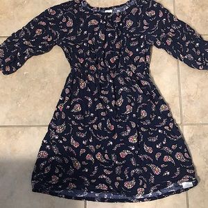 Kids Floral Blue Dress With Cropped Sleeves And A Button On The Front.